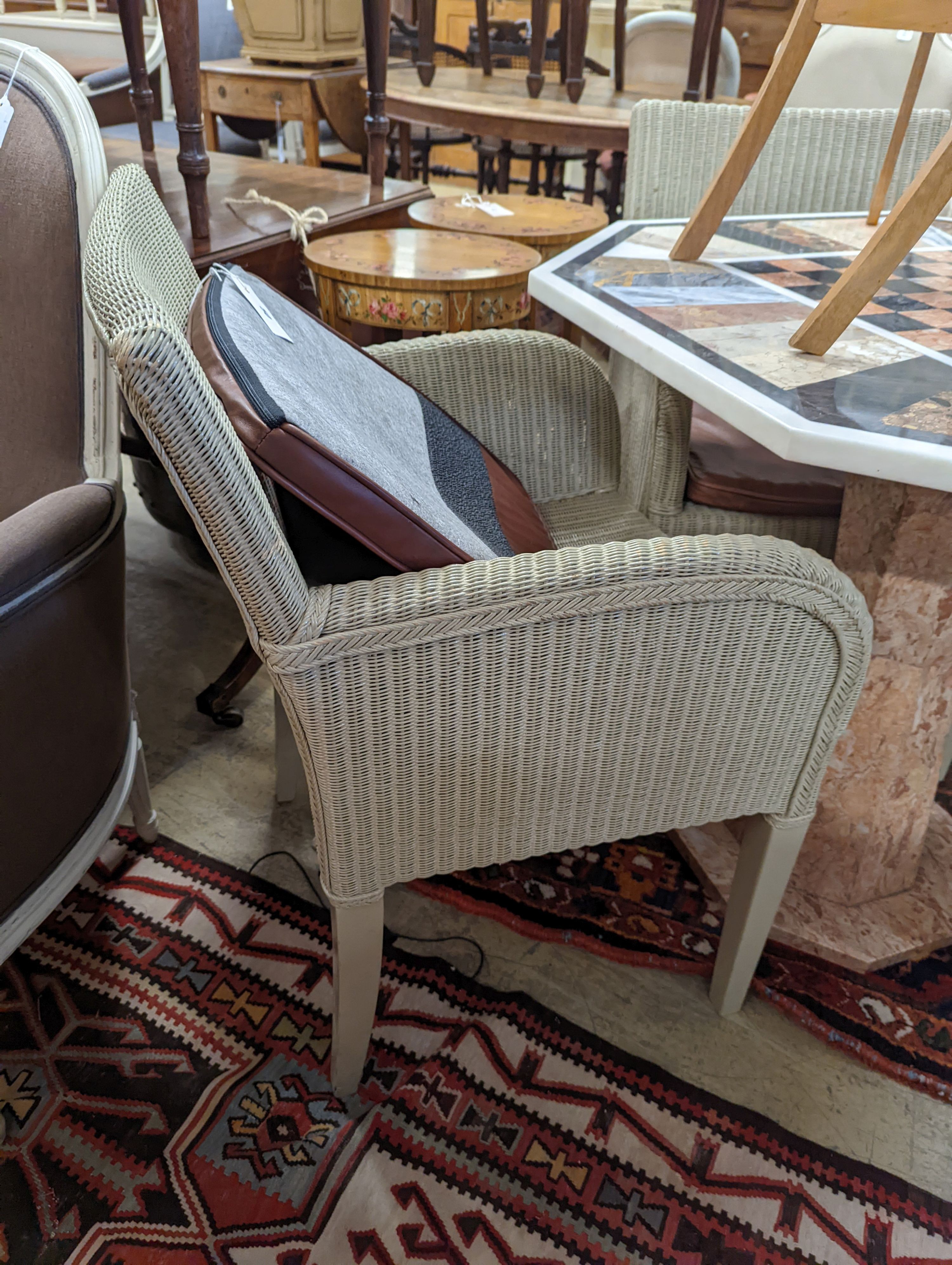 Vincent Sheppard, a set of four conservatory chairs with tan leather seats